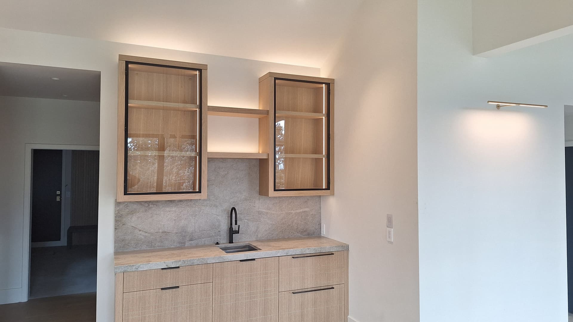 Sleek Kitchen and Bathroom Redesign with Elegant Lighting image