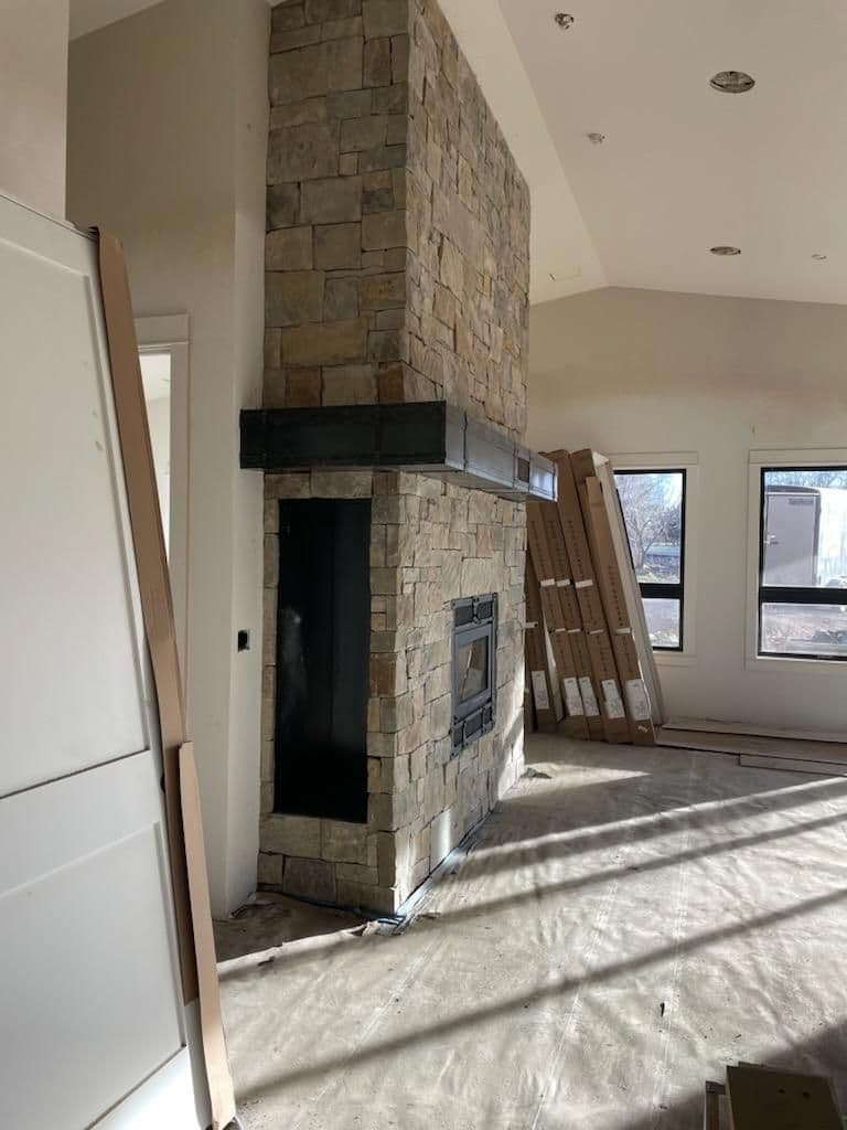 Cozy Room Makeover with Stone Fireplace and Ambient Lighting image